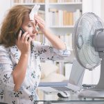 Image of person in front of fan. When Do I Replace My Air Conditioner?