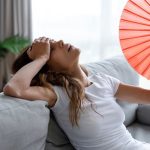Image of someone who looks like they're struggling with heat. Why Is My AC Blowing Hot Air?.